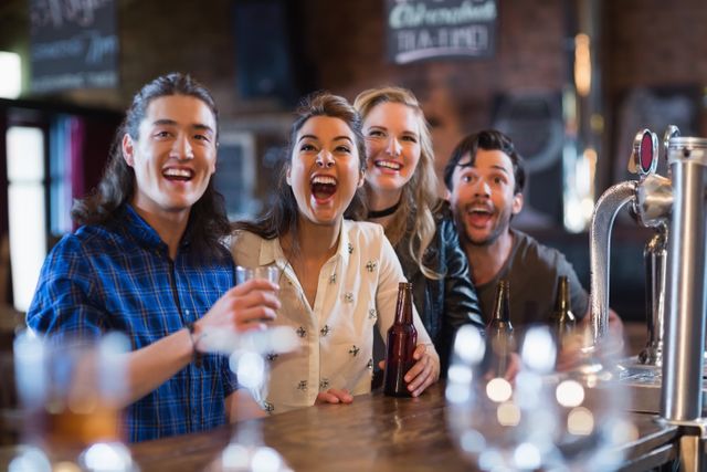 Group of friends standing at bar counter, enjoying drinks and having fun. Perfect for themes related to social gatherings, nightlife, friendship, and leisure activities. Ideal for use in advertisements, social media posts, and promotional materials for bars, pubs, and social events.