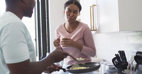 Couple enjoying cooking in modern kitchen, building relationships