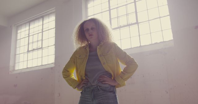 Confident Young Woman with Curly Hair in Casual Outfit, Backlight from Window - Download Free Stock Images Pikwizard.com