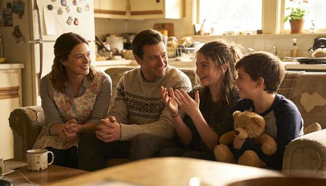 Cozy family conversation on worn sofa parents listening daughter sharing story with son