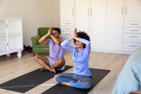 Diverse Friends Practicing Yoga Together at Home for Mindfulness