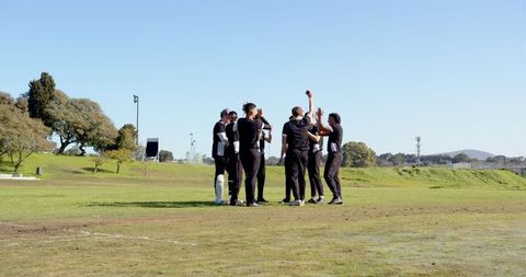 Cricket Team Celebrating Victory Outdoors