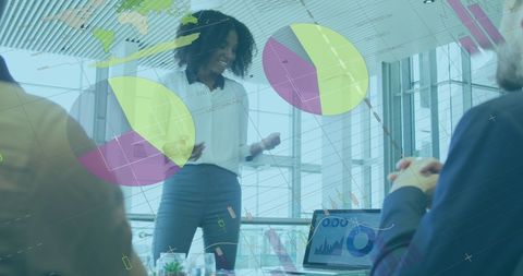 African American Woman Presenting Data in Modern Office