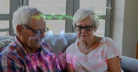 Senior couple monitoring heart health with digital interface