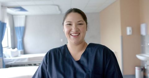 Smiling Female Doctor in Hospital Ward