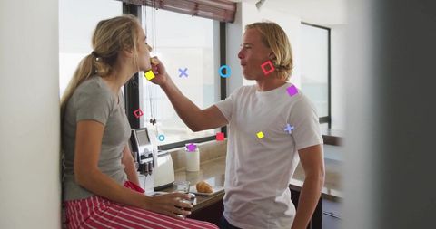 Joyful Couple Sharing Breakfast at Home Kitchen in Morning Light