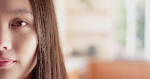 Serene Woman Gazing Thoughtfully in Sunlit Room