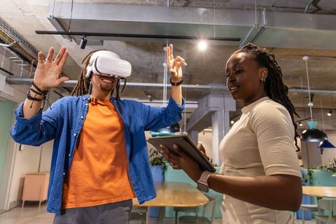 Coworking Team Demonstrating Virtual Reality Training and Collaboration in Workspace