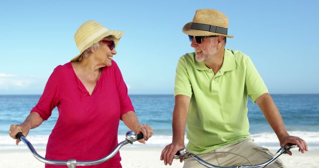 Senior Couple Enjoying Bicycle Ride on Beach - Download Free Stock Images Pikwizard.com