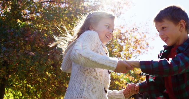 Happy Children Playing Outdoors Holding Hands in Autumn - Download Free Stock Images Pikwizard.com