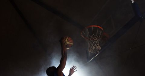 Basketball Player Executing Flawless Dunk Under Dramatic Lighting - Download Free Stock Images Pikwizard.com