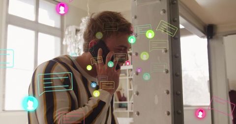 Young professional engaging in phone call with digital interfaces