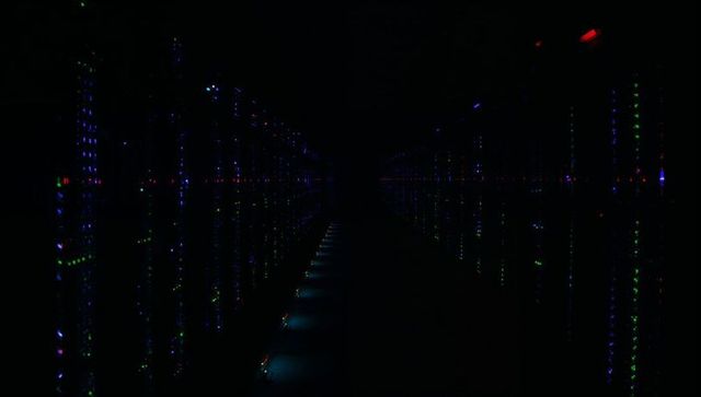 Glowing Server Rack Aisle Illuminating Dark Data Center Corridor with LED Floor Lights