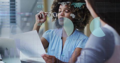 Women Analyzing Data at Modern Office Environment