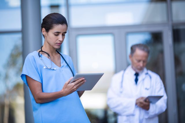 Doctor and nurse using digital tablet in hospital