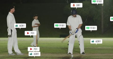 Batsman swinging under floodlights with social media notifications in night cricket match