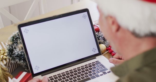 Senior Man Wearing Santa Hat Using Laptop at Home During Christmas - Download Free Stock Images Pikwizard.com