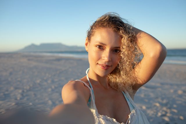 Beautiful Woman Taking Selfie on Beach at Sunset - Download Free Stock Photos Pikwizard.com
