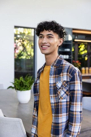 Cheerful Young Man Standing in Modern Home Interior, Flannel Shirt Style