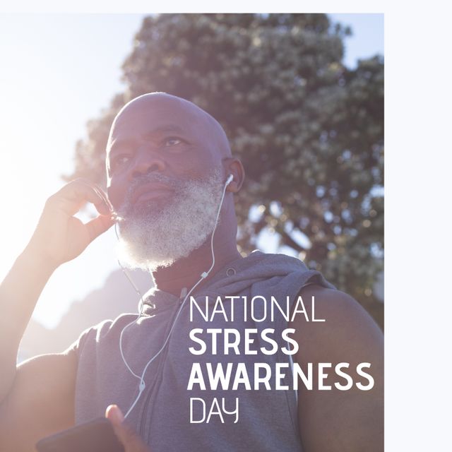 Senior African American man wears earphones while engaging in mindfulness and wellness activities outdoors. This image can be used to promote mental health awareness, relaxation techniques, stress management, and National Stress Awareness Day initiatives.