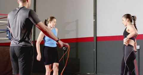 Trio jumping rope during boxing gym cardio circuit training session for group fitness