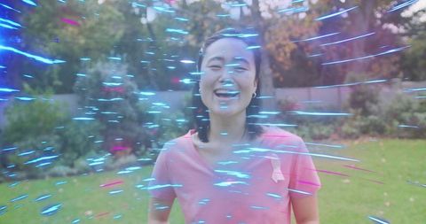 Joyful Woman Embracing Vibrant Nature in Backyard