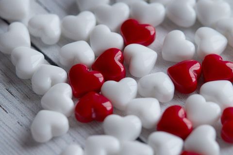 Scattered Heart Shaped Candies on Wooden Surface