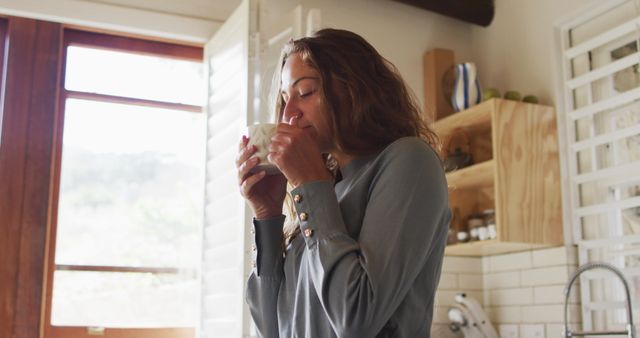 Woman Enjoying Morning Coffee in Cozy Kitchen Setting - Download Free Stock Images Pikwizard.com