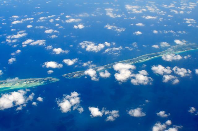 Aerial View of Tropical Islands and Blue Ocean Covered with Clouds - Download Free Stock Photos Pikwizard.com