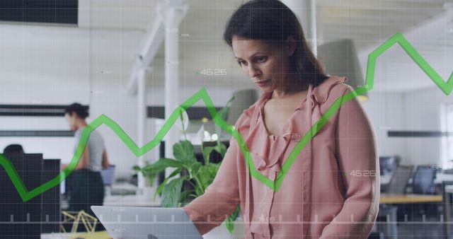 Businesswoman Analyzing Stock Market Data on Laptop in Modern Office - Download Free Stock Images Pikwizard.com