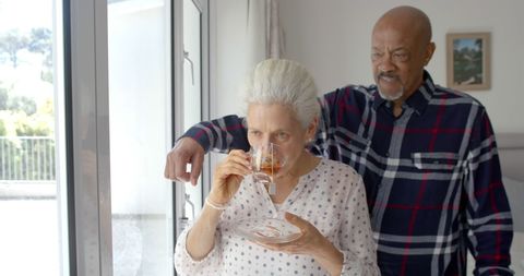 Senior Couple Enjoying Tea by Bright Window at Home