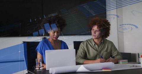 Business Team Reviewing Data Charts and Plans in Office Meeting