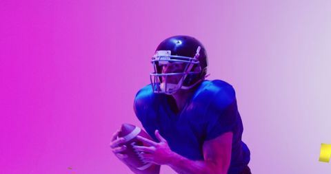 American Football Player with Ball on Vibrant Pink Background