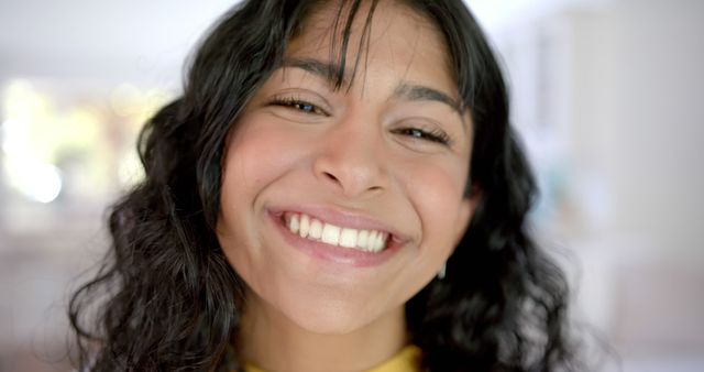 Closeup of Smiling Young Woman with Curly Hair at Home - Download Free Stock Images Pikwizard.com