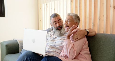 Senior Couple Enjoying Quality Time with Laptop at Home