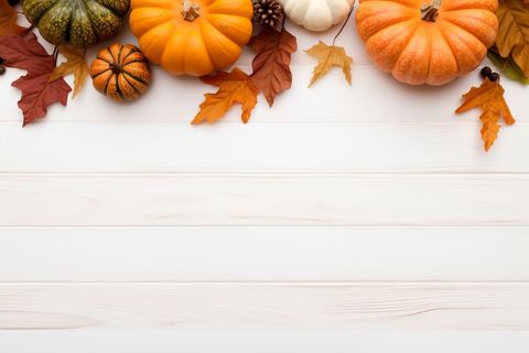 Autumn Pumpkins and Leaves Arrangement on Wooden Background