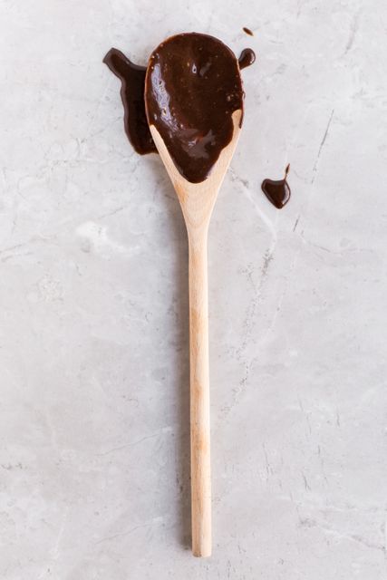 Wooden Spoon with Chocolate Spatters on Marble Surface - Download Free Stock Photos Pikwizard.com