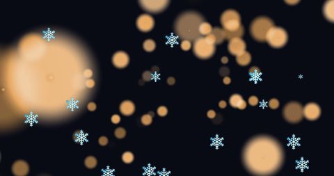 Snowflakes falling over warm festive lights
