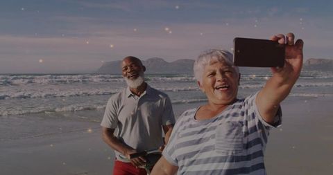 Senior Couple Taking Selfie on Beach Enjoying Sunset