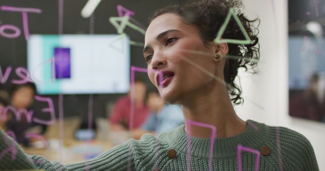 Businesswoman Drawing Diagram on Glass Board in Modern Office - Download Free Stock Images Pikwizard.com