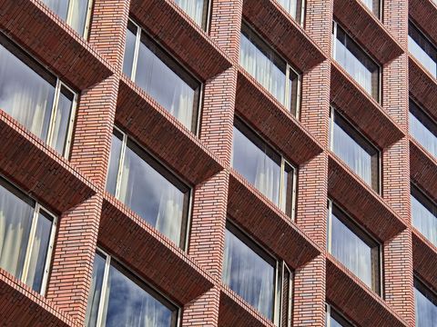 Geometric brick condo building with reflective windows