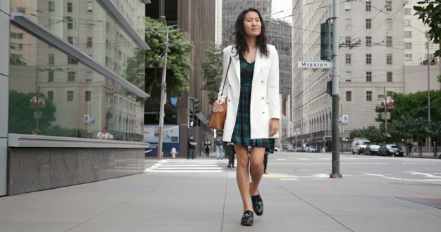 Confident Woman Strolling on City Street in Elegant Dress and Blazer - Download Free Stock Images Pikwizard.com