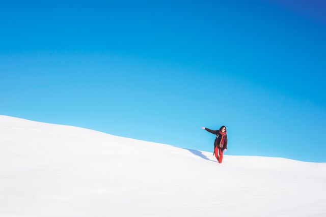 Young Woman Standing in Snowy Landscape with Clear Blue Sky - Download Free Stock Photos Pikwizard.com