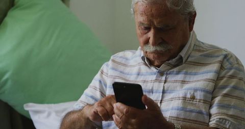Senior Caucasian Man in Retirement Home Using Smartphone