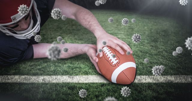 American football player in action on the field with a focus on a football amid floating virus symbols representing the COVID-19 pandemic. Highlighting the impact of the coronavirus on sports, events, and health. Suitable for articles on sports safety, pandemic effects on sports, and health precautions in athletic activities.