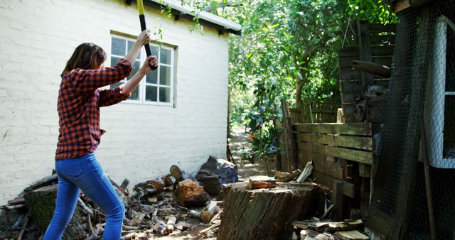 Young Woman Chopping Firewood in Backyard - Download Free Stock Images Pikwizard.com