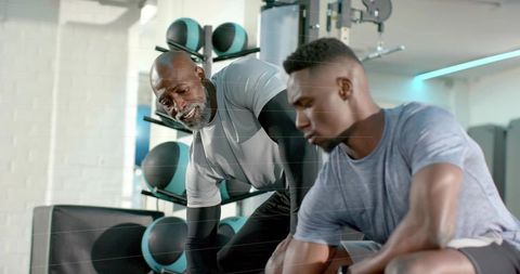 Trainer Guiding Young Athlete Through Strength and Technique Session in Modern Gym