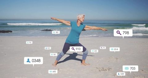 Elderly Woman Practicing Yoga Warrior Pose on Beach