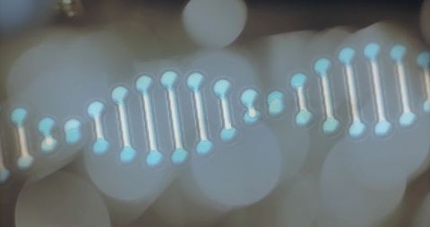 Glowing dna helix stretching with cyan nodes and bokeh lights for futuristic science background