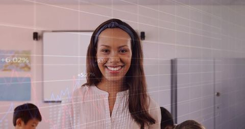 Smiling teacher guiding students with digital data overlays and whiteboard in classroom